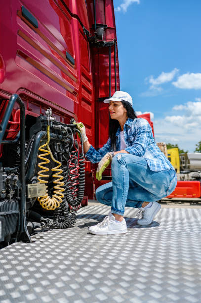 the professional female truck driver checks the correctness of the truck